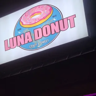 a neon sign for luna donut