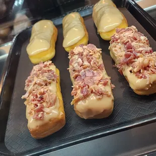 four doughnuts covered in bacon and cheese