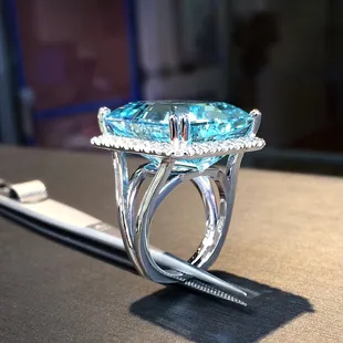 Large emerald cut Aquamarine in Diamond Halo ring