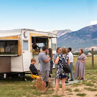 a group of people standing in front of a food truck