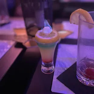 a margarita and a lemon wedge on a table