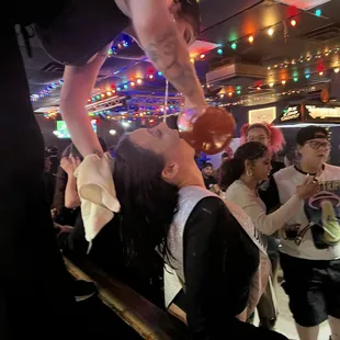 a woman holding a baby in the air