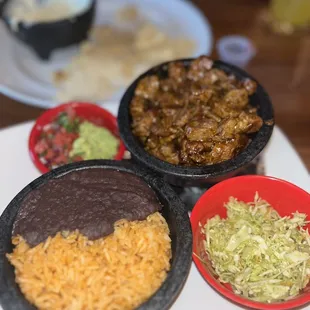 three bowls of mexican food on a table