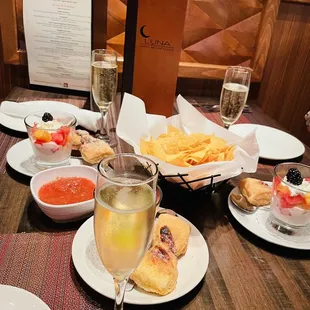 Champagne brunch with yogurt, fruits, sweet baked bread