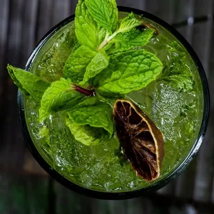 a cocktail with mint and orange