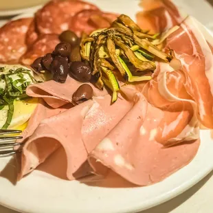 Handmade creation: olives, meats, fresh mozzarella, and mushroom.