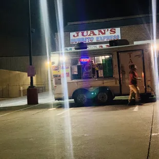 a man standing in front of a food truck