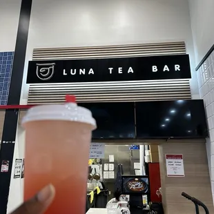 Strawberry sparkling tea with mango jelly in front of tea bar