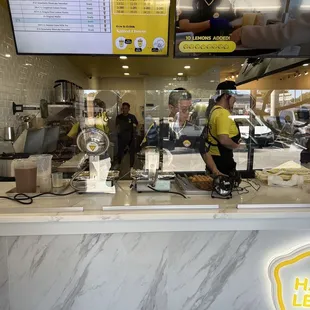 two workers working behind the counter