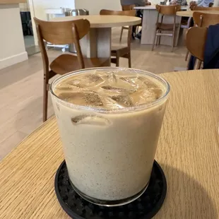 a glass of iced coffee on a table