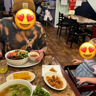 a man and a woman sitting at a table with bowls of food