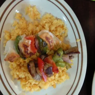 Mediterranean skewers over yellow rice