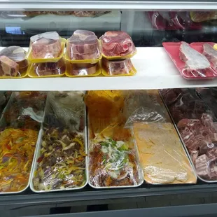 Chicken and beef fajitas, breaded chicken, beef shanks, pork pieces, avocado salsa, and arrachera.