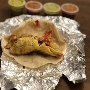 a taco wrapped in tin foil