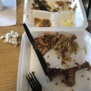 a half eaten meal in a styrofoam container