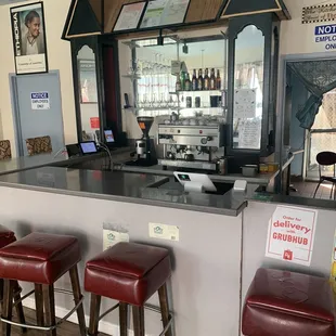a bar with red leather stools