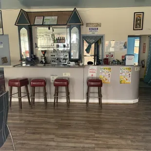 a bar with red stools