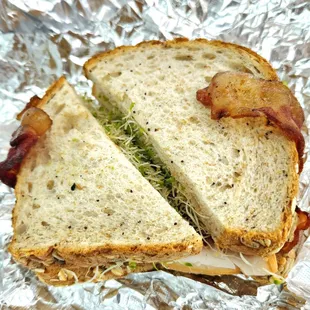 California Turkey (Smoked turkey, swiss chs, bacon, sprouts, avocado on 12 grain bread - no mayo, tomato), $7.99. Very filling.