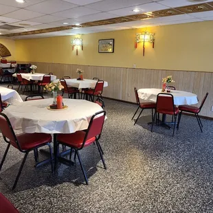tables and chairs with white tablecloths