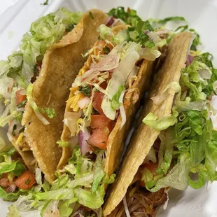 two tacos in a styrofoam container