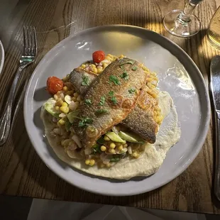 Pan Seared Branzino with saffron fregola, shaved asparagus, fava beans, blistered tomatoes, lemon and cauliflower puree.