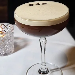a glass of coffee on a table