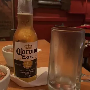 a bottle of corona extra and a glass of beer