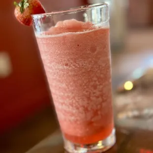 a strawberry in a glass