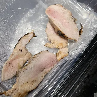 two pieces of fish in a plastic container