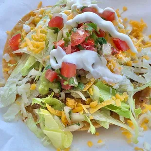 Shredded Beef Tostada. Tortilla fresh fried to order. Bigger than a taco with more veg. Nice, light meal, just $3.75.