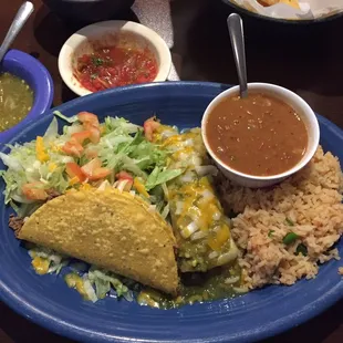 Lunch combo. Jalapeño chicken enchilada with green chili sauce and beef taco. Sides of rice &amp; charo beans. Delicioso!
