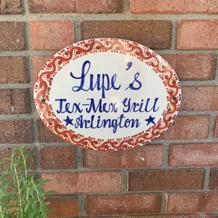a sign on a brick wall