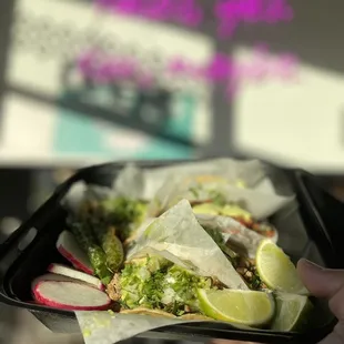 a person holding a tray of food