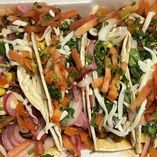 Four pork carnitas tacos.