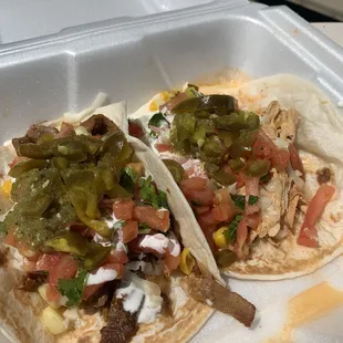 two tacos in a styrofoam container