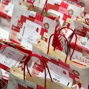 a lot of red and white shopping bags