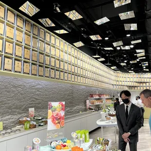 two men standing in front of a buffet