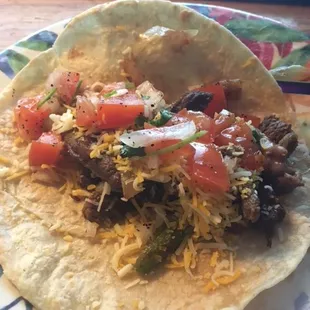 Beef fajita tacos with pico de gallo.
