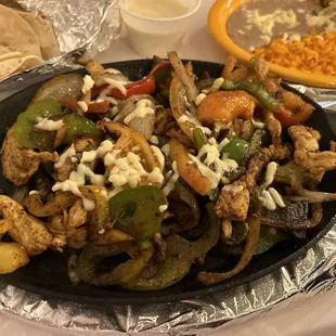 Chicken Fajitas, beans, rice, and guacamole salad