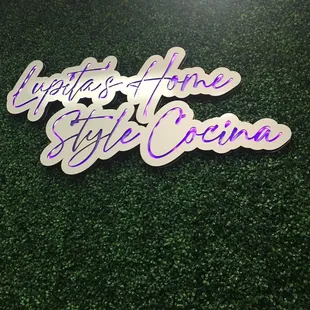 a purple and white sticker with the words lupita's home style co