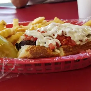 Sonora dog- hot dog wrapped with jalapeno, mozzarella, sour cream with fries.