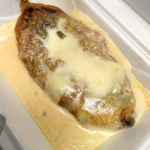 a close up of a piece of food in a styrofoam container