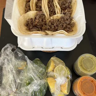 Asada tacos with everything in the side, to go
