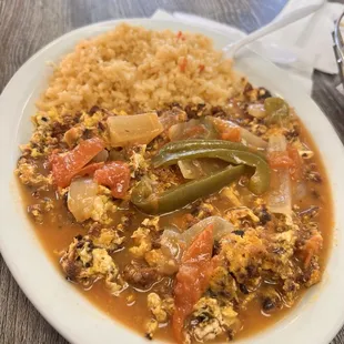Chorizo and egg smothered in wet burrito sauce (custom order).
