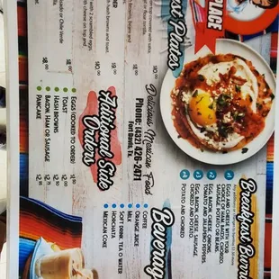 a hand holding a menu