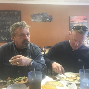 two men eating a meal