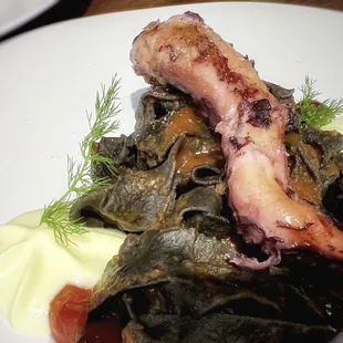 GRILLED OCTOPUS OVER SQUID INK PASTA