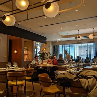 people sitting at tables in a restaurant