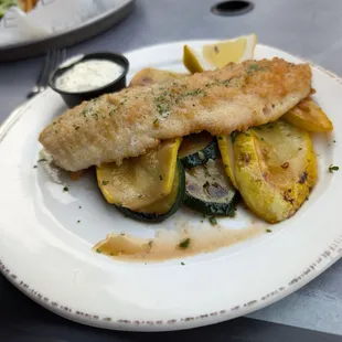Walleye with grilled zucchini and squash, and a tasty tartar sauce. In the background is a burger with really good fries.