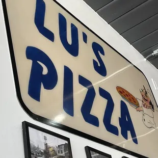 a sign for lu&apos;s pizza